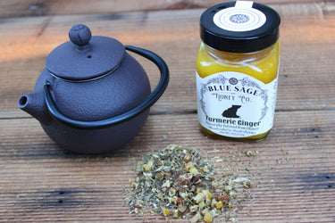 Chamomile herbal tea served in cast iron teapot with turmeric honey