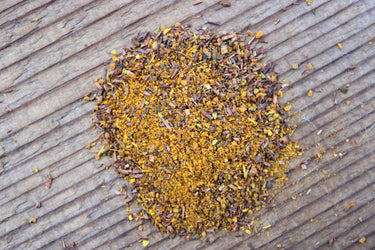 Close-up of Turmeric Chai Rooibos loose leaf tea showing yellow turmeric and red rooibos