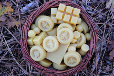 Wicker basket of bulk yellow beeswax cappings and blocks