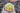 Top view of 2oz yellow beeswax peony candle with cotton wick in cupped hand