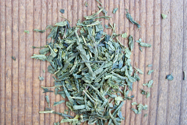 Loose leaf organic sencha green tea on wood