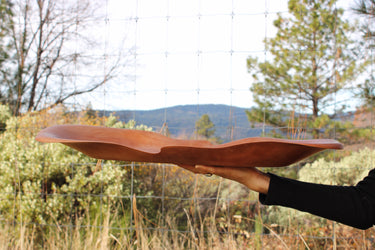 Side profile of large Madrone tray showing thin curling edges and shallow wavy bowl