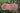Top view of asymmetrical natural edge Madrone wooden tray with fluid grain patterns