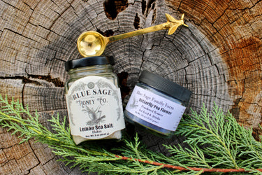 The Inquisitive Chefs Bundle with lemon sea salt, butterfly pea flower powder, and brass bee spoon on wood