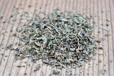 Close-up of calming Tulsi herbal tea showing varied leaf texture and natural colors