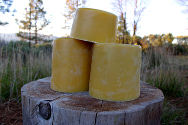 Golden yellow beeswax brick pyramid in natural light