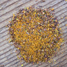Close-up of Turmeric Chai Rooibos loose leaf tea showing yellow turmeric and red rooibos