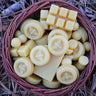 Wicker basket of bulk yellow beeswax cappings and blocks