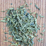 Loose leaf organic sencha green tea on wood