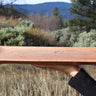 Tan oak wooden serving tray with recessed center held outdoors