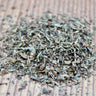 Close-up of calming Tulsi herbal tea showing varied leaf texture and natural colors