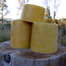 Golden yellow beeswax brick pyramid in natural light